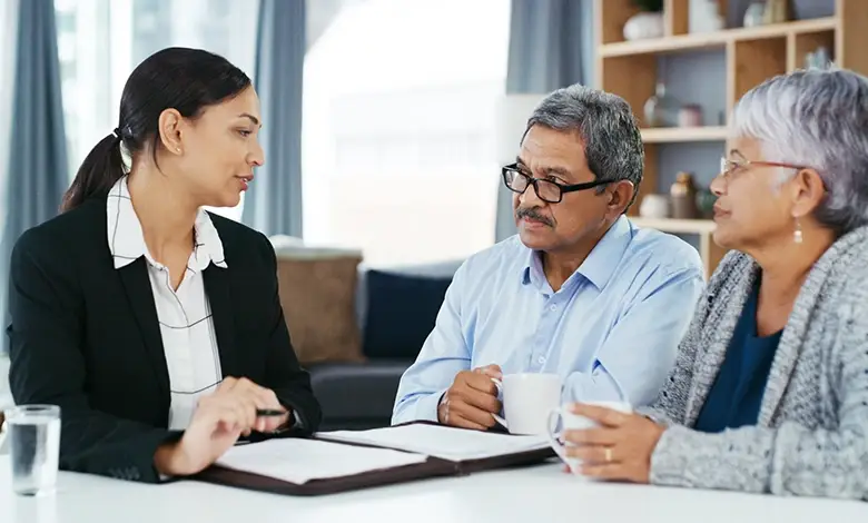 Insurance Agent Discussing Policy Options with Couple in an Office