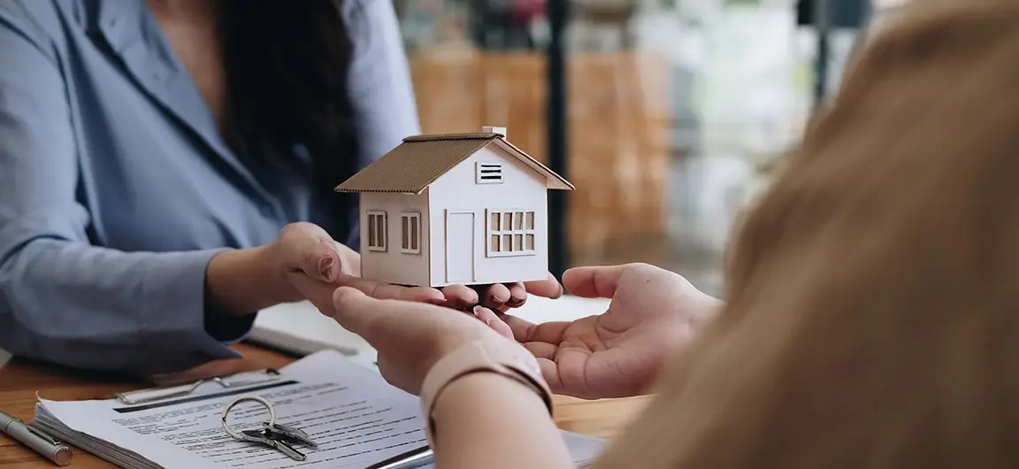 Hands Holding Model House with Insurance Agent in White Bear Lake MN